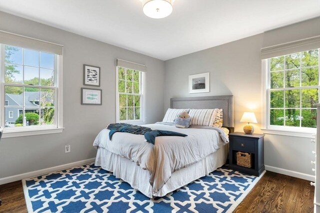 bedroom featuring baseboards and wood finished floors