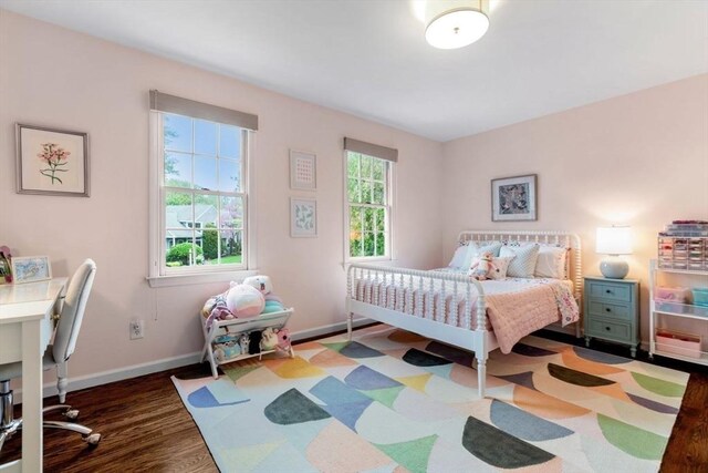 bedroom with wood finished floors and baseboards