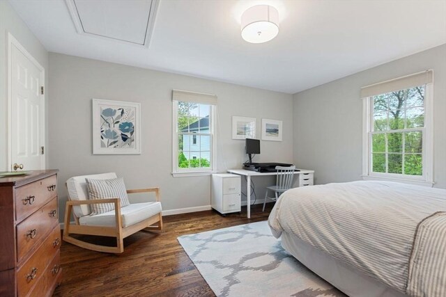 bedroom with dark wood-type flooring and baseboards