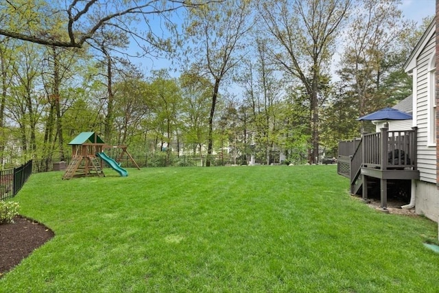 view of yard with a deck and a playground