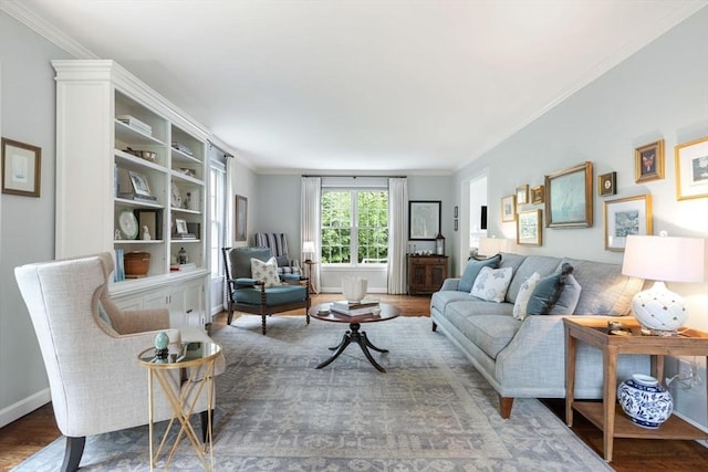 living room with crown molding, wood finished floors, and baseboards