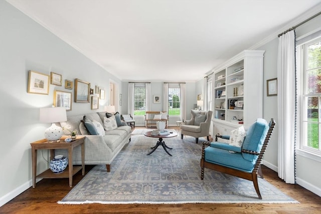 living room featuring wood finished floors, healthy amount of natural light, and baseboards