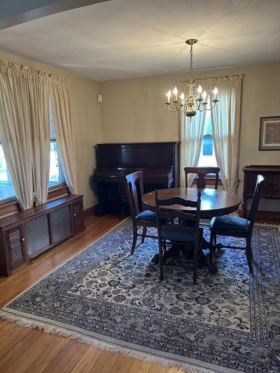 dining area featuring hardwood / wood-style flooring and a chandelier