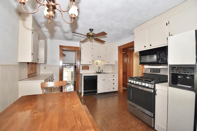 kitchen with white cabinetry, sink, black appliances, and ceiling fan with notable chandelier