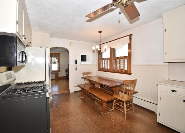 dining room featuring ceiling fan with notable chandelier and a baseboard radiator