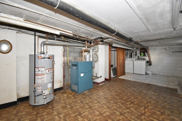 basement featuring independent washer and dryer, gas water heater, and dark parquet flooring