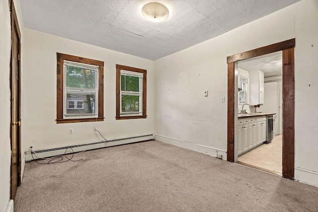 19-21 Pleasant St, North Andover, MA 01845 - empty room with a baseboard heating unit, light carpet, and a sink