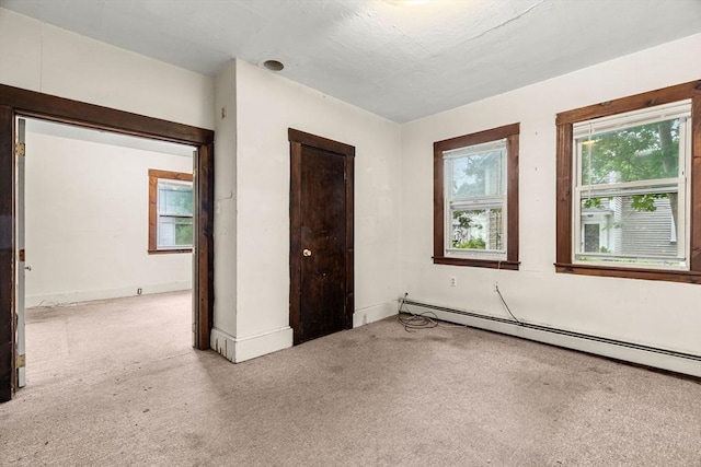 19-21 Pleasant St, North Andover, MA 01845 - unfurnished bedroom with baseboard heating, carpet flooring, and baseboards