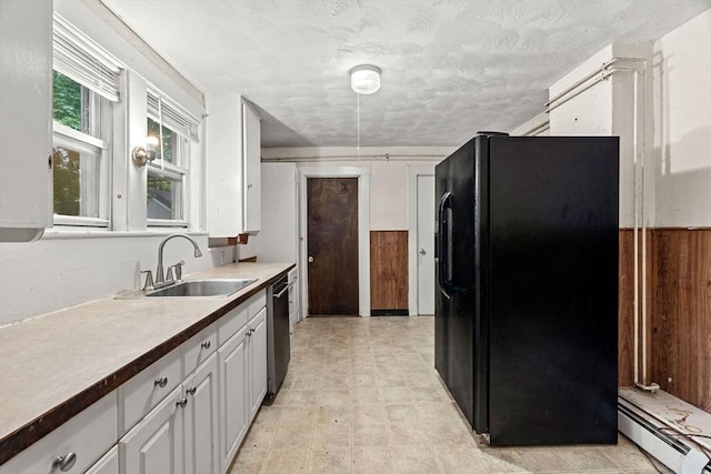 19-21 Pleasant St, North Andover, MA 01845 - kitchen with black fridge with ice dispenser, a baseboard radiator, a sink, stainless steel dishwasher, and white cabinets