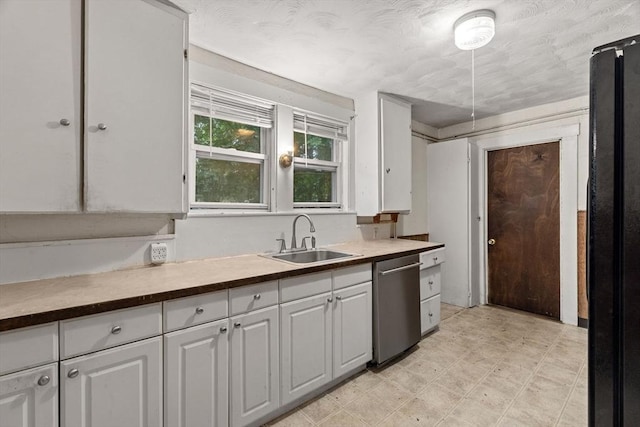 19-21 Pleasant St, North Andover, MA 01845 - kitchen with stainless steel dishwasher, a sink, white cabinets, and freestanding refrigerator