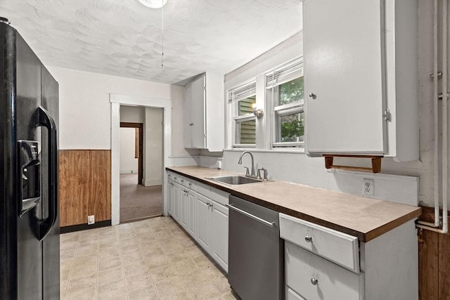 19-21 Pleasant St, North Andover, MA 01845 - kitchen featuring black fridge with ice dispenser, dishwasher, a sink, light floors, and wainscoting