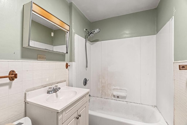 19-21 Pleasant St, North Andover, MA 01845 - bathroom featuring tile walls, vanity, shower / tub combination, wainscoting, and toilet