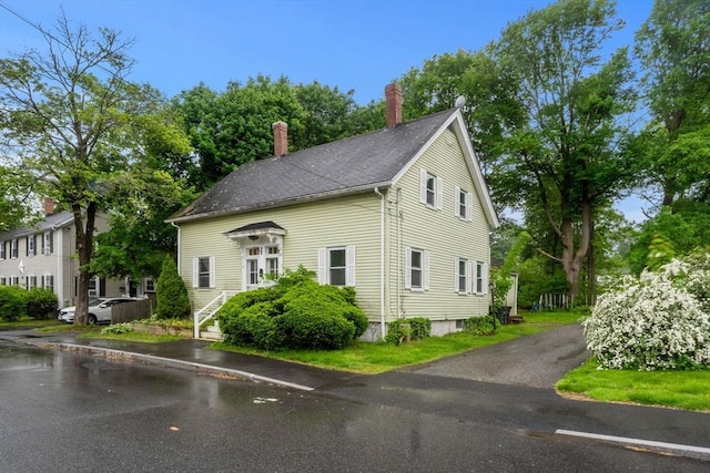 19-21 Pleasant St, North Andover, MA 01845 - view of property exterior featuring a chimney and uncovered parking