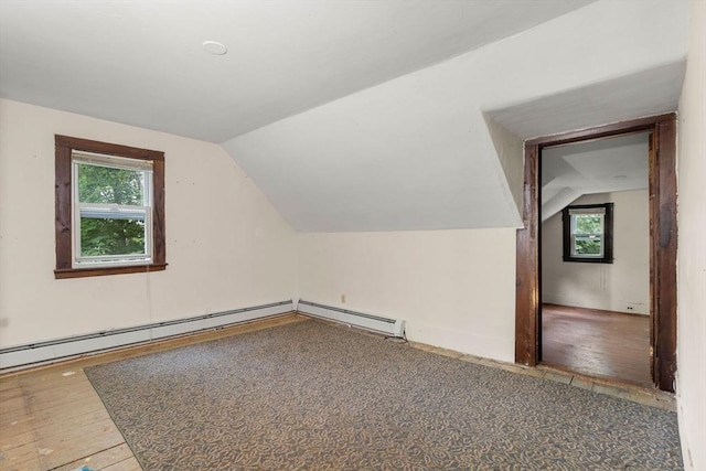 19-21 Pleasant St, North Andover, MA 01845 - additional living space with vaulted ceiling, plenty of natural light, wood finished floors, and a baseboard heating unit