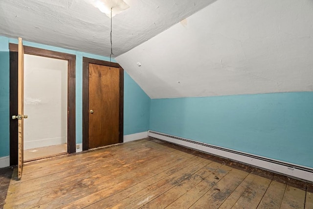 19-21 Pleasant St, North Andover, MA 01845 - additional living space featuring a baseboard radiator, wood-type flooring, vaulted ceiling, and baseboards