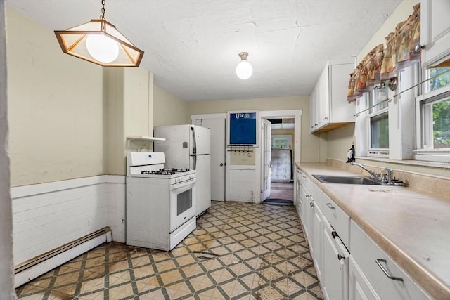 19-21 Pleasant St, North Andover, MA 01845 - kitchen featuring white gas range, baseboard heating, white cabinetry, a sink, and light countertops