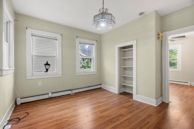 19-21 Pleasant St, North Andover, MA 01845 - unfurnished dining area with a baseboard radiator, light wood-style floors, and baseboards