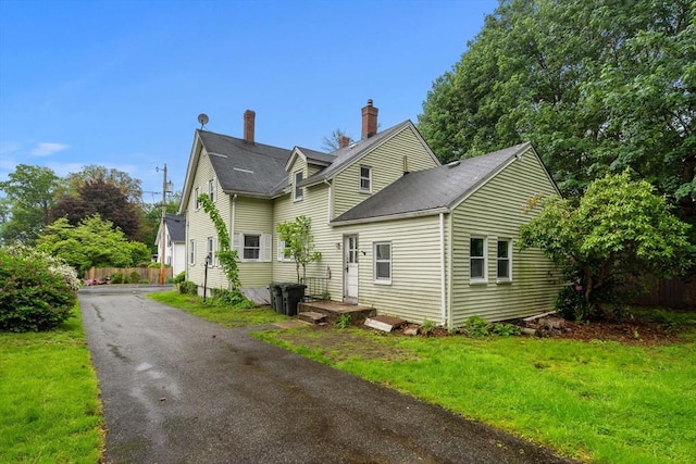 19-21 Pleasant St, North Andover, MA 01845 - view of side of home with roof with shingles and a chimney