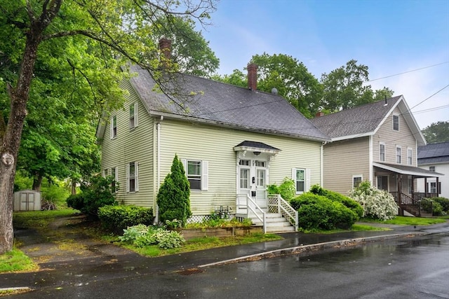 19-21 Pleasant St, North Andover, MA 01845 - view of front of property featuring a chimney and roof with shingles