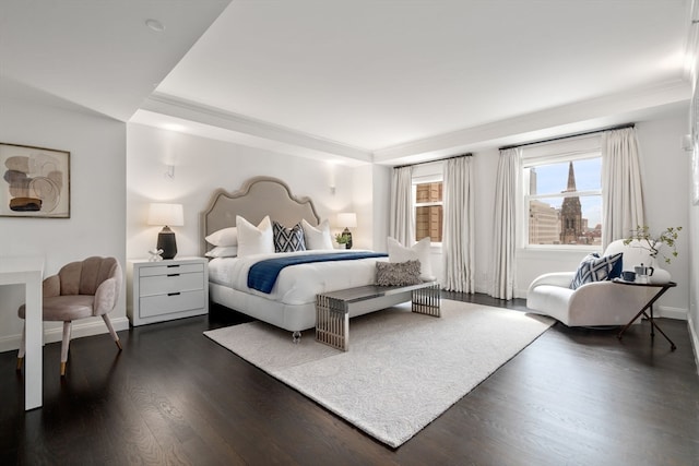 bedroom featuring a tray ceiling and dark hardwood / wood-style floors