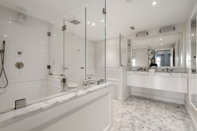 bathroom with a tile shower, dual bowl vanity, and tile flooring