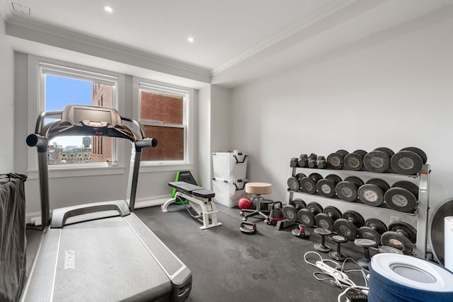 exercise room with crown molding and concrete flooring