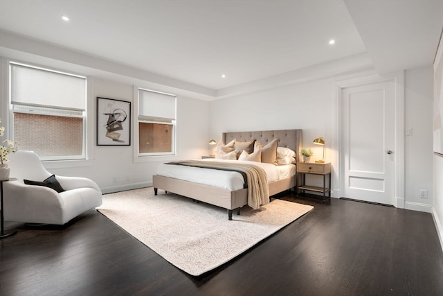 bedroom with dark wood-type flooring