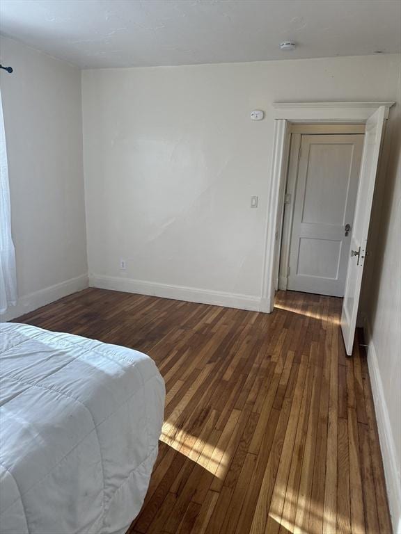 bedroom featuring dark hardwood / wood-style flooring