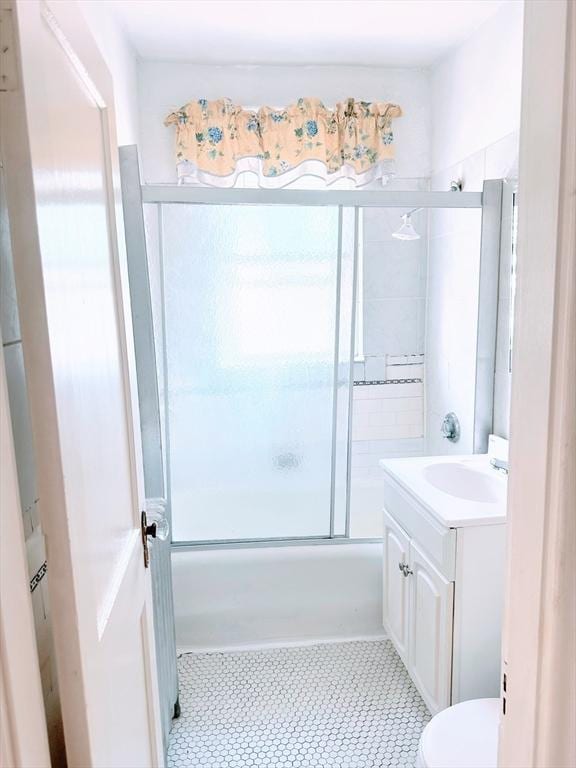 full bathroom with shower / bath combination with glass door, vanity, and toilet