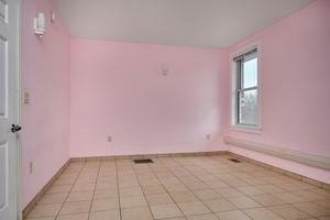 unfurnished room featuring light tile patterned floors and baseboards