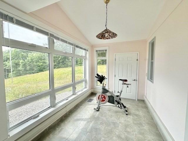 workout room with baseboards and lofted ceiling