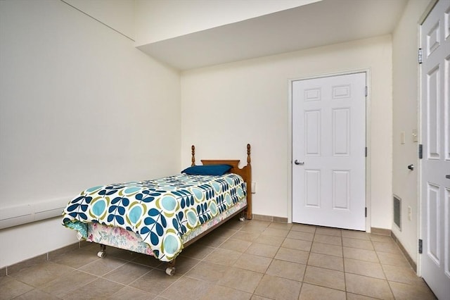 bedroom featuring visible vents, baseboards, and tile patterned flooring