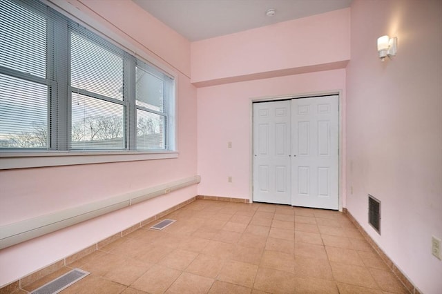 unfurnished bedroom with visible vents, baseboards, and a closet