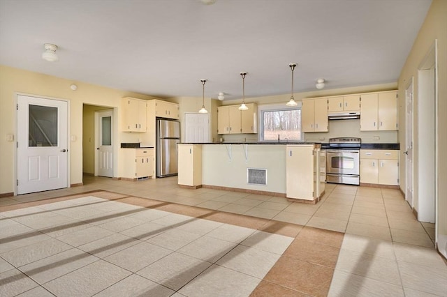 kitchen with visible vents, under cabinet range hood, dark countertops, stainless steel appliances, and light tile patterned flooring