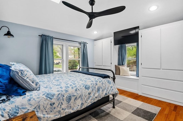 bedroom with multiple windows, light wood finished floors, recessed lighting, and ceiling fan