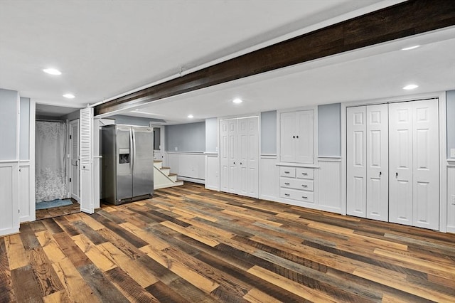 finished below grade area with stainless steel fridge with ice dispenser, dark wood-style floors, stairs, recessed lighting, and wainscoting