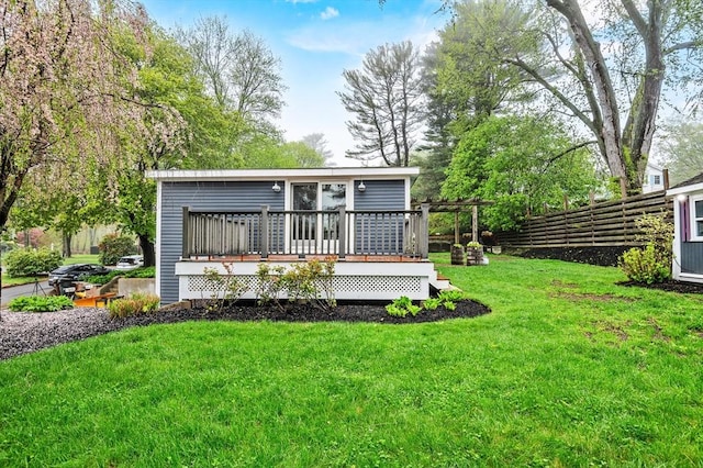 rear view of property featuring a wooden deck