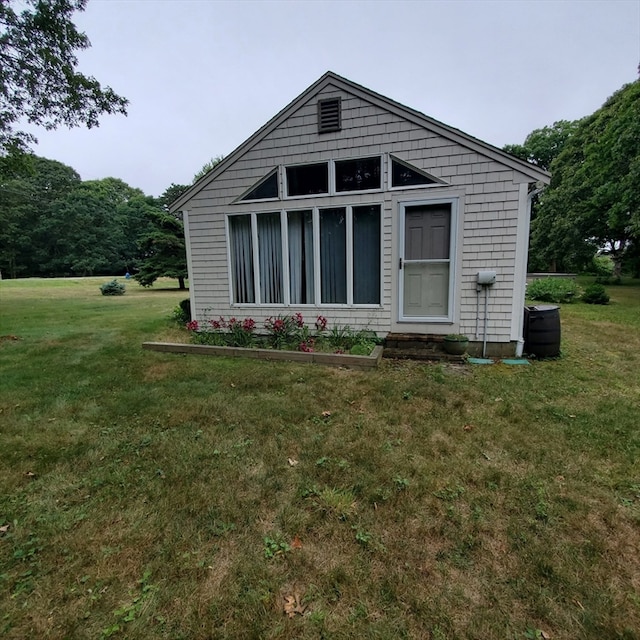 rear view of house featuring a lawn