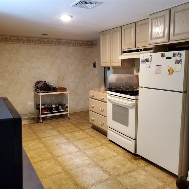 kitchen with premium range hood, white appliances, and light tile patterned floors