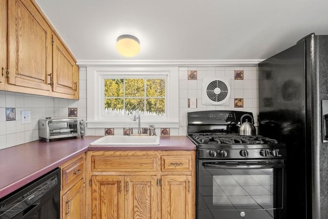 kitchen featuring sink, decorative backsplash, and black appliances