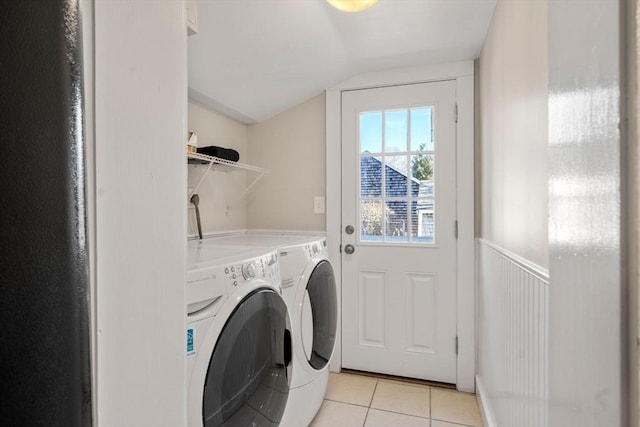 washroom featuring washing machine and dryer and light tile patterned flooring