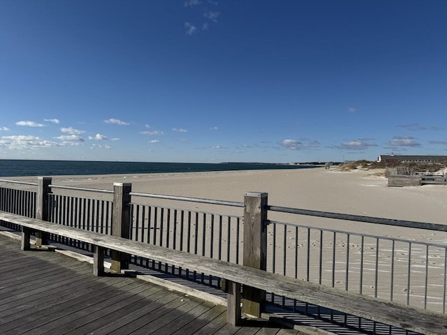 view of dock with a view of the beach and a water view