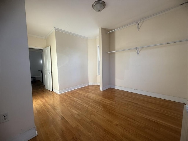 unfurnished bedroom with ornamental molding, radiator, and hardwood / wood-style floors