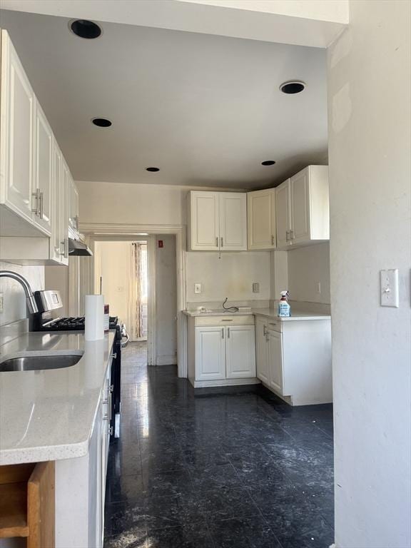 kitchen featuring sink and white cabinets