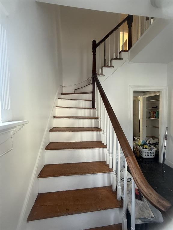 staircase featuring a high ceiling