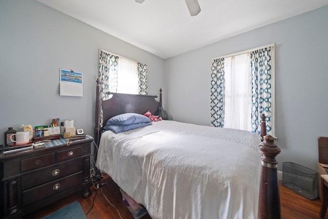 bedroom with dark wood-style flooring and a ceiling fan