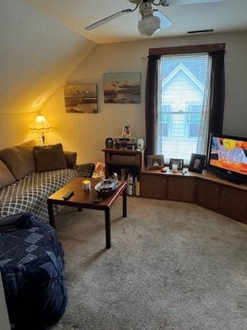 carpeted living room featuring ceiling fan and lofted ceiling