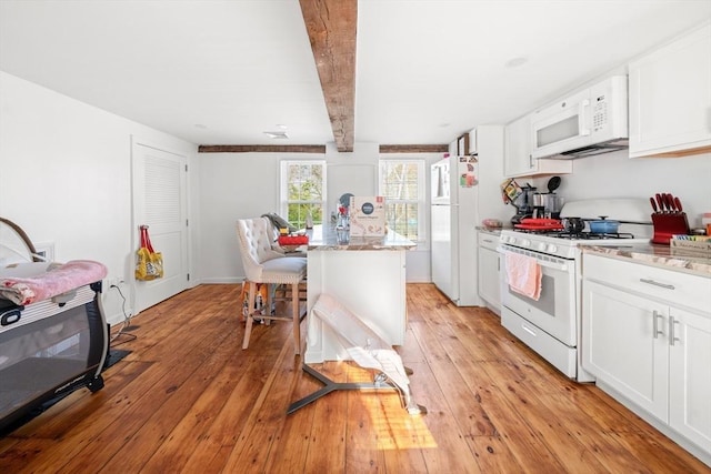 101 Old Westport Rd, Dartmouth, MA 02747 - kitchen featuring white appliances, white cabinets, beamed ceiling, light stone countertops, and light wood finished floors