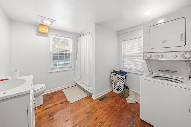 101 Old Westport Rd, Dartmouth, MA 02747 - laundry room with stacked washer / dryer and wood-type flooring