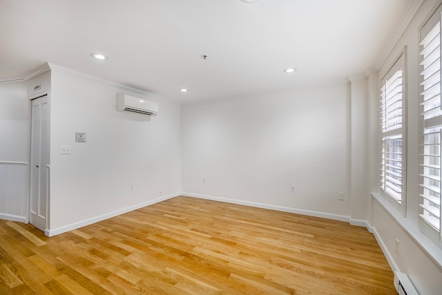 unfurnished room featuring a wall mounted air conditioner, light hardwood / wood-style flooring, ornamental molding, and a healthy amount of sunlight